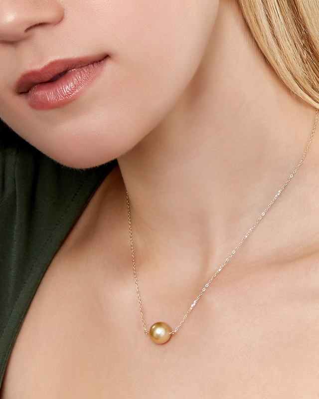 Model is wearing The Golden Solitaire Pendant with 10mm AAAA quality pearls