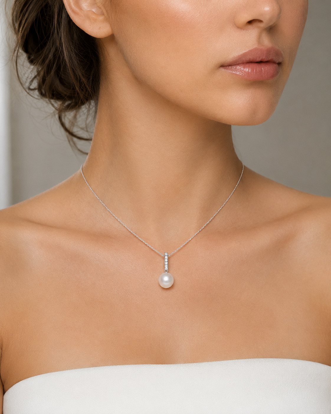 Model is wearing Dangling Diamond Pendant with 9-10mm AAAA quality pearls